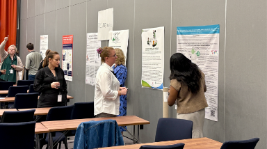 Conference participants looking at posters