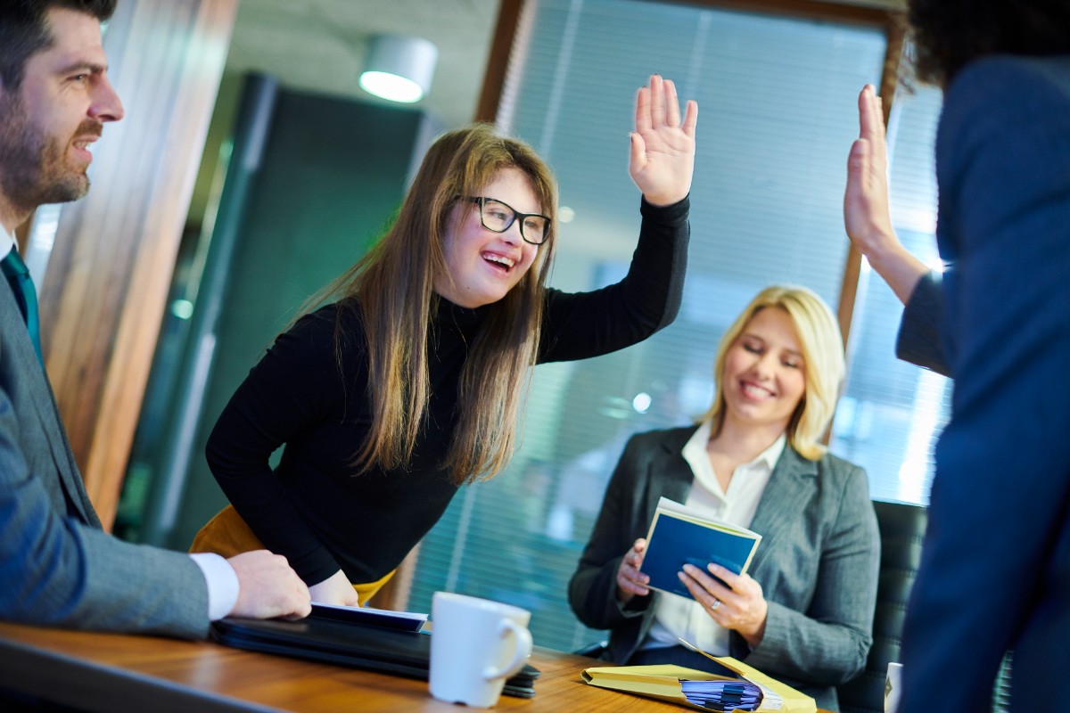 Young woman in a meeting giving a high five