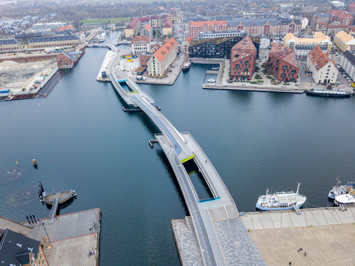 Aerial view of Copenhagen’s Inner Harbour Bridge connecting the waterfront areas across the harbour, surrounded by historic and modern buildings.