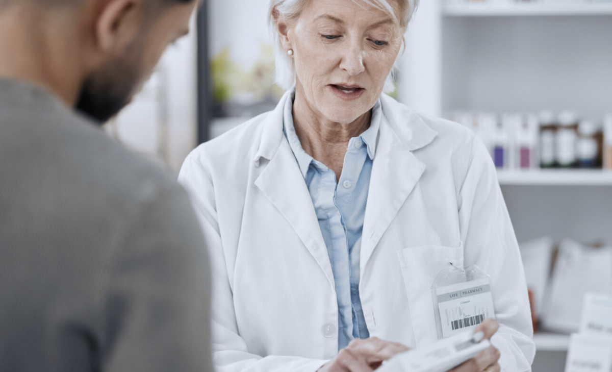 Female pharmacist talking to a customer.