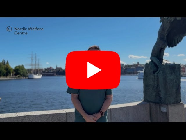 A man stands by the waterfront on a sunny day with the Nordic Welfare Centre logo in the corner. He speaks directly to the camera, reminding viewers to register for the Nordic Conference on Deafblindness 2026.